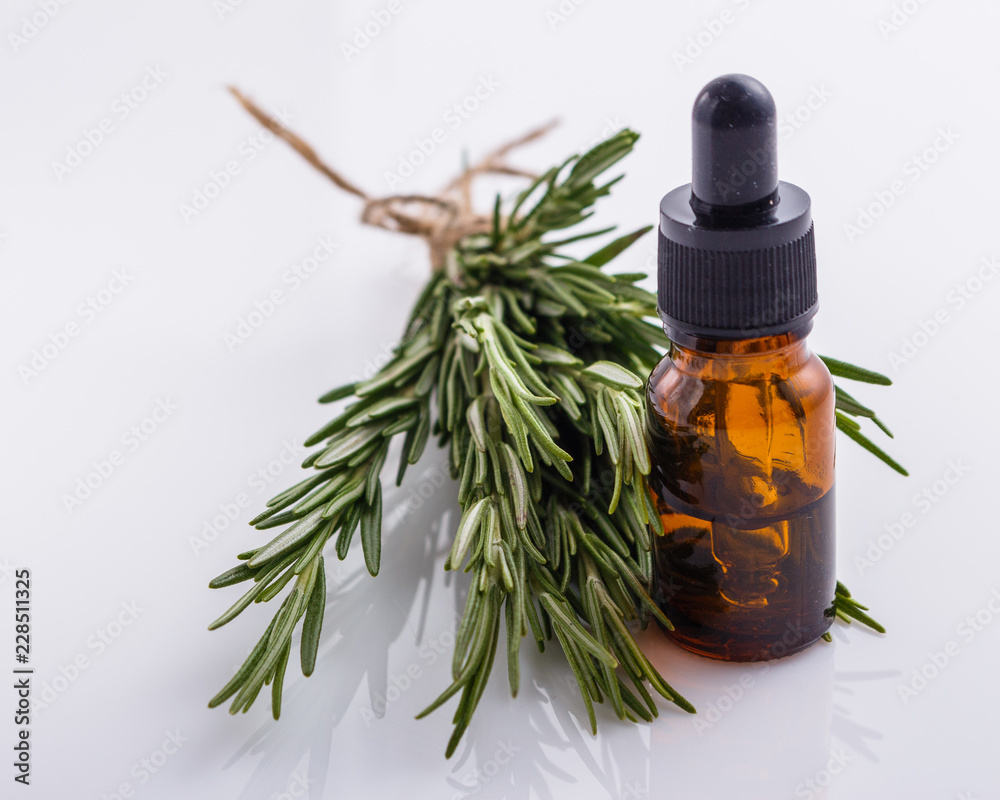 Rosemary essential oil on a white background Rosemary essential oil on a white background