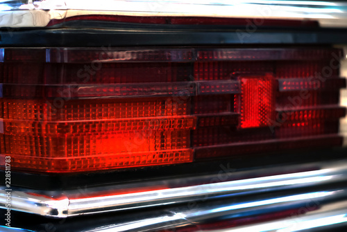 fragment of the backlight of a black vintage luxury car..