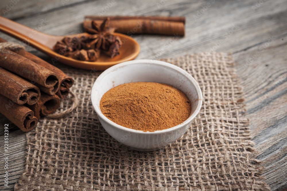 Cinnamon sticks on wooden background.
