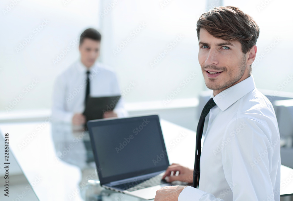 rear view.successful businessman sitting at the office Desk rear view.successful businessman sitting at the office Desk