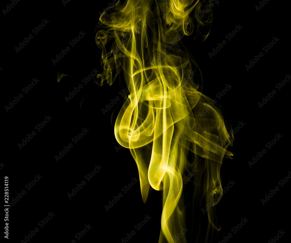 Obraz premium Yellow smoke on black background