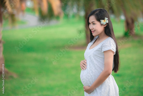 Portrait of young pregnant woman at the park,Thailand people
