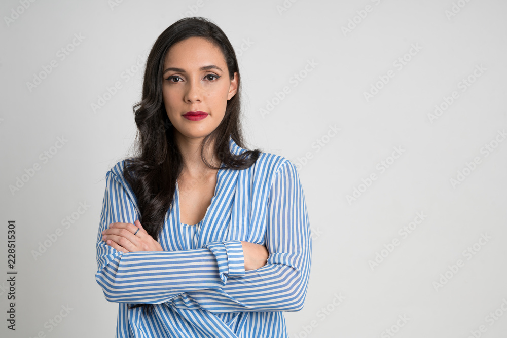 Serious and beautiful woman looking at camera with arms crossed Serious and beautiful woman looking at camera with arms crossed