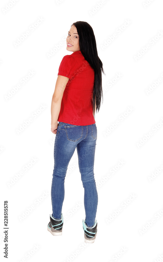 Beautiful woman standing in red blouse looking over shoulder Beautiful woman standing in red blouse looking over shoulder