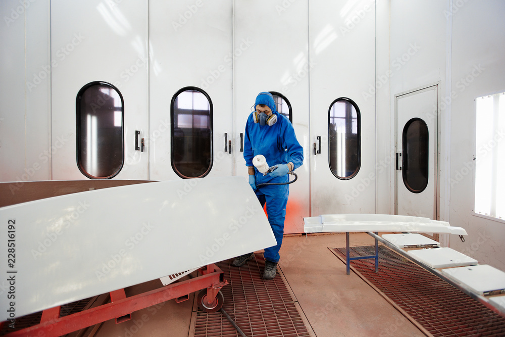 Paint and varnish camera. The worker paints a detail. Production of fiberglass details of the boat and car Paint and varnish camera. The worker paints a detail. Production of fiberglass details of the boat and car