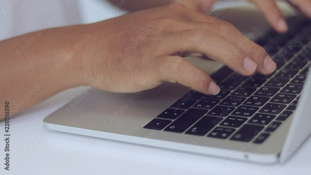 Male students are using hand prints on the notebook keyboards. Male students are using hand prints on the notebook keyboards.
