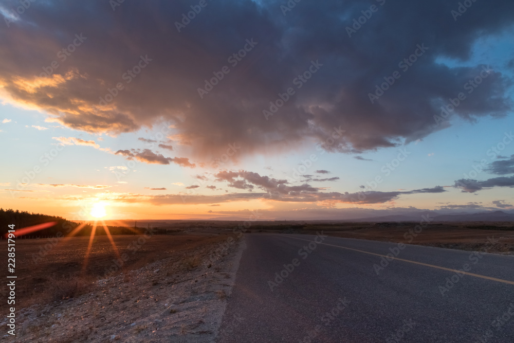 asphalt road in sunset