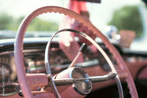 Steering wheel of a pink classic car photo