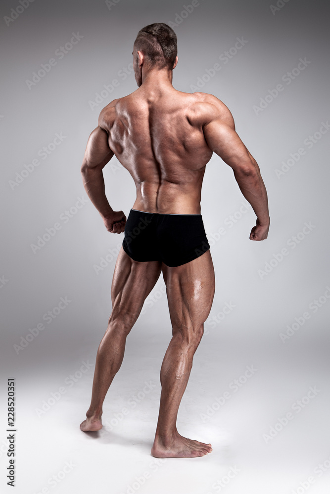 Strong Athletic Man Fitness Model posing back muscles