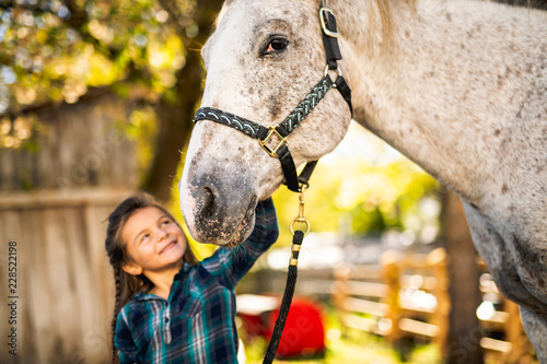 in a beautiful Autumn season of a young girl and horse