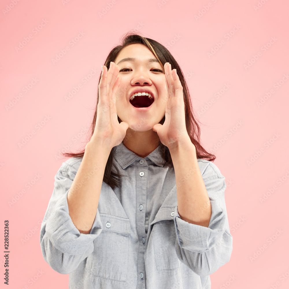 Do not miss. Young casual woman shouting. Shout. Crying emotional woman screaming on studio background. Female half-length portrait. Human emotions, facial expression concept. Trendy colors Do not miss. Young casual woman shouting. Shout. Crying emotional woman screaming on studio background. Female half-length portrait. Human emotions, facial expression concept. Trendy colors