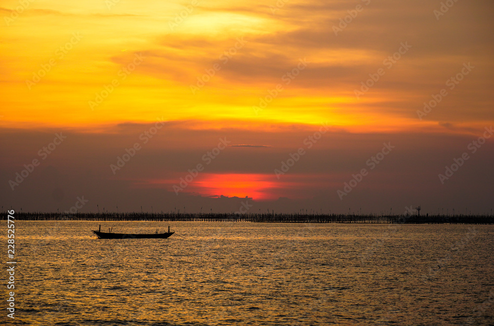 Small fishing boat with sunset light