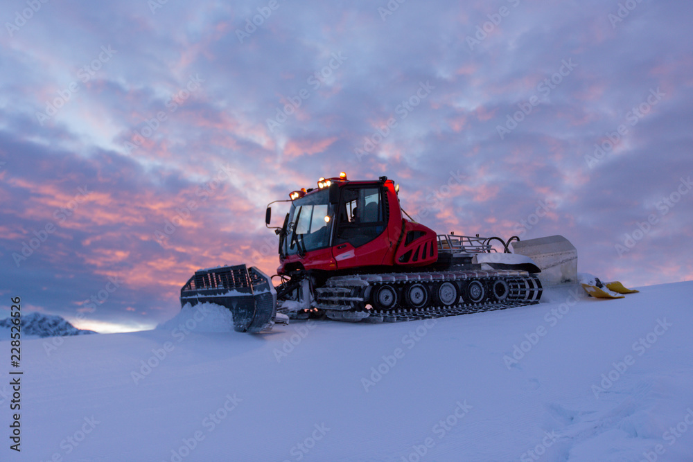 Obraz premium Snowplow machine at snowy ski resort