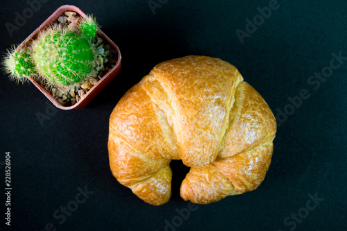 Tasty buttery croissants on old wooden table.