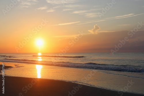 Beautiful sunrise over the ocean nature background.Southern marine landscape with sun rising over the atlantic ocean at the Huntington Beach State Park, Litchfield, Myrtle Beach area, South Carolina.