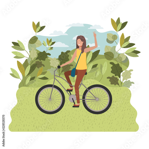 young woman in bicycle on the park