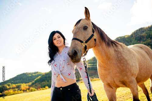 A Woman with her horse at sunset, autumn outdoors scene