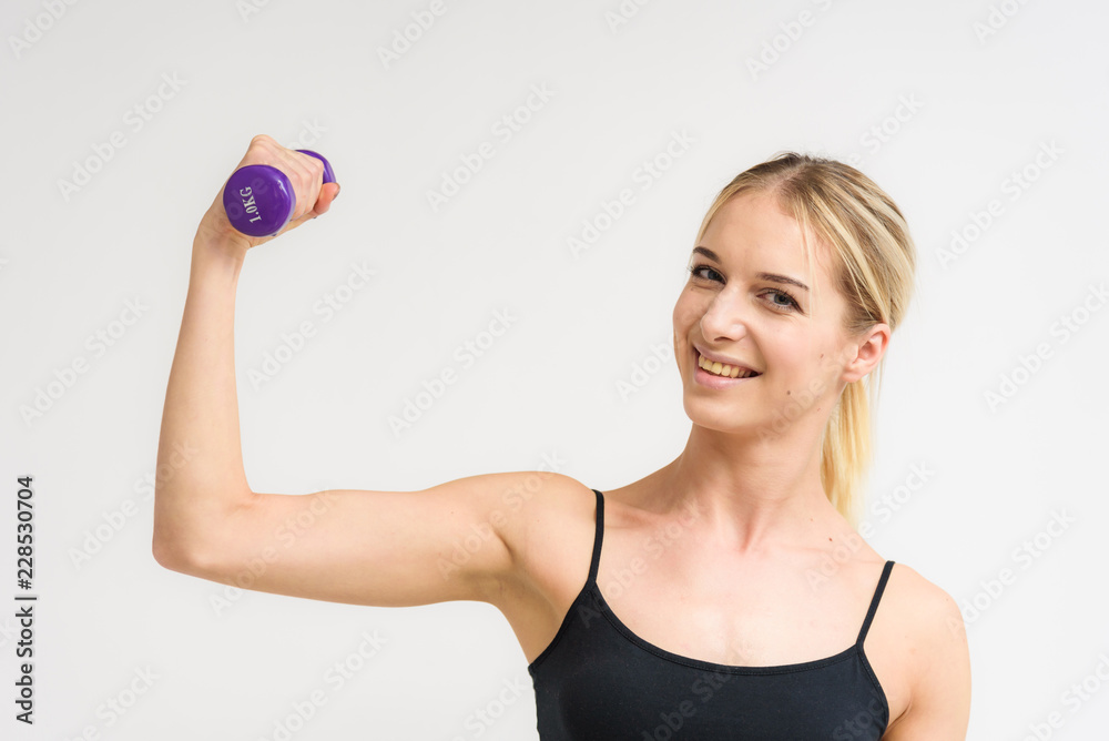 Studio photo of a beautiful blonde girl doing fitness stretching exercises on a white background. Studio photo of a beautiful blonde girl doing fitness stretching exercises on a white background.