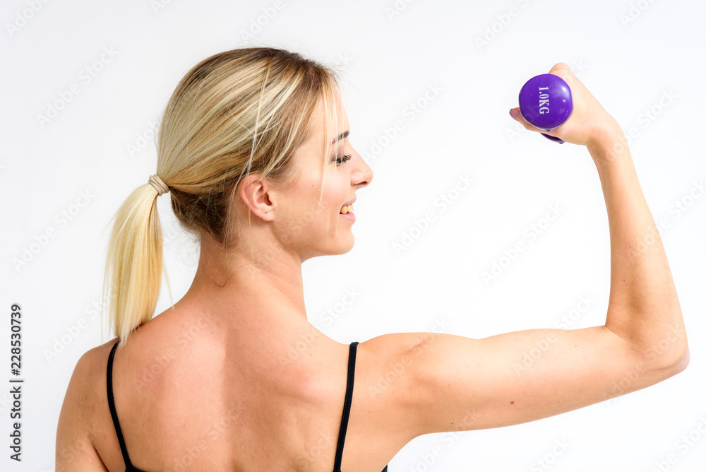 Studio photo of a beautiful blonde girl doing fitness stretching exercises on a white background. Studio photo of a beautiful blonde girl doing fitness stretching exercises on a white background.