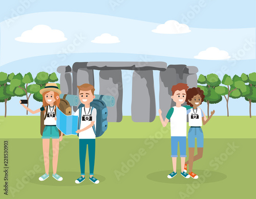 women and men friends with backpack in the stonehenge