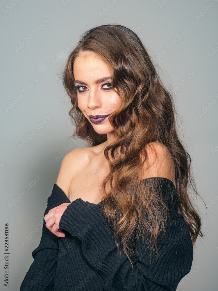 Fototapeta premium Beauty salon and hairdresser. Makeup cosmetics and skincare. woman with fashion makeup and long curly hair. Fashion portrait of woman. fashion girl with glamour makeup. Glamour fashion model