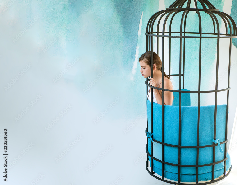 imagintion and inspiration. modern furniture design and home comfort.  prisoner woman in cage. fashion slave in captivity of beauty. freedom of  girl in cage chair. woman in cage, copy space Stock Photo