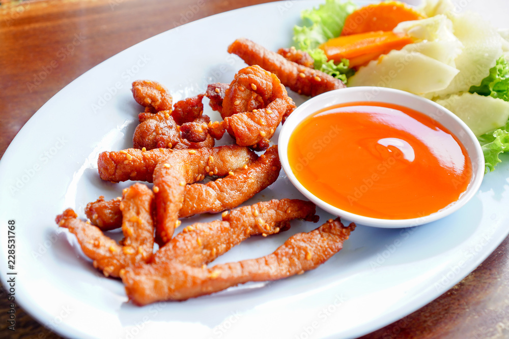 Thai Food,Single pork sunny fry put white sesame on wooden table and pickle Thai Food,Single pork sunny fry put white sesame on wooden table and pickle