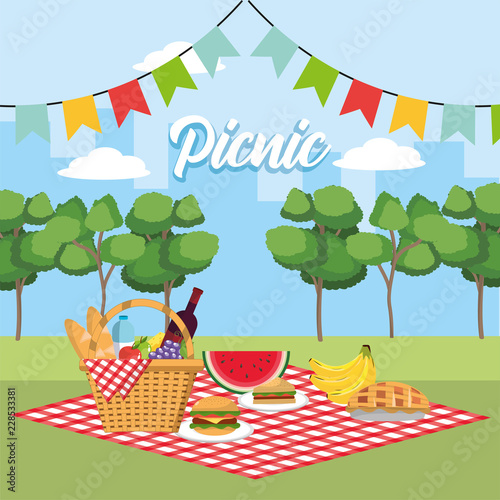 basket with healthy fruits in the tablecloth and party flags