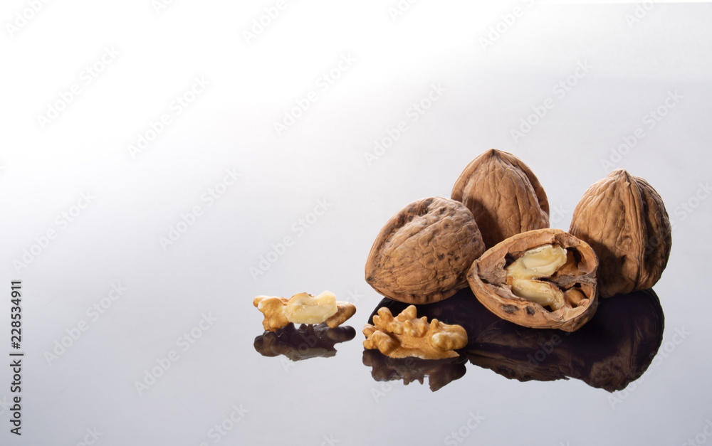 walnuts on bright background with reflection walnuts on bright background with reflection