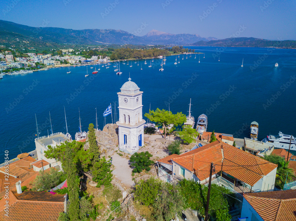 The clock tower of Poros island, Greece. Aerial drone photo