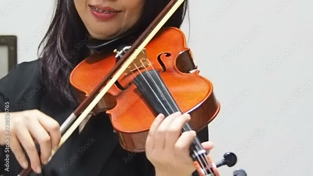 The lady is playing voilin