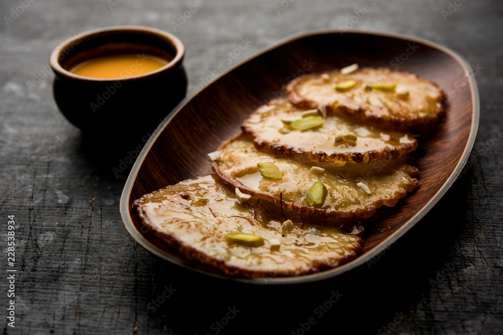 Malpua sweet - Traditional Indian dessert or pancake for festivals, served in plate with rabri/rabdi . selective focus
