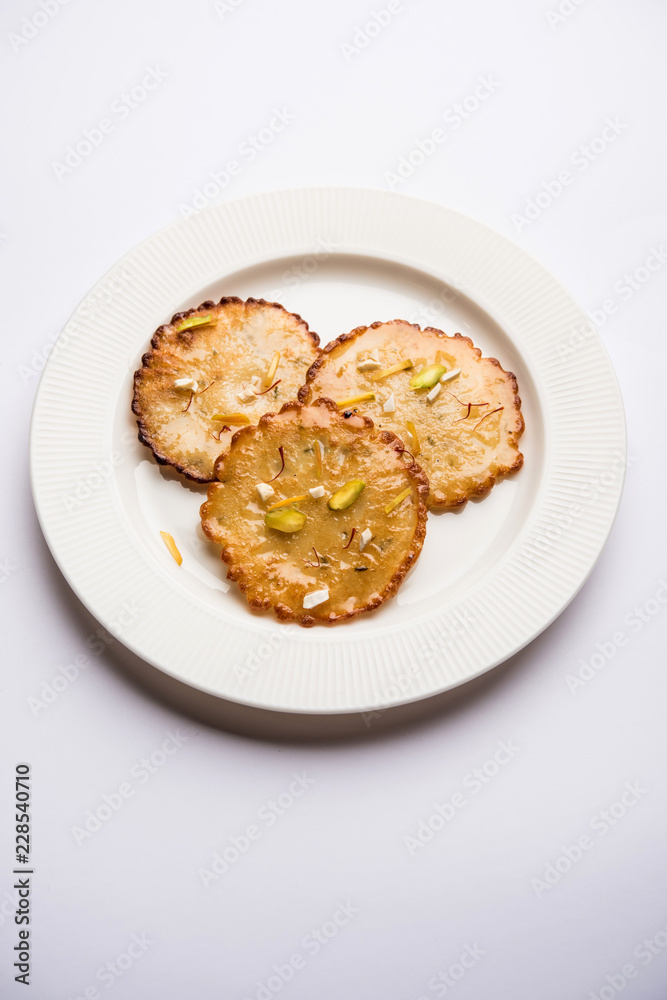 Malpua sweet - Traditional Indian dessert or pancake for festivals, served in plate with rabri/rabdi . selective focus