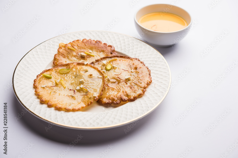 Malpua sweet - Traditional Indian dessert or pancake for festivals, served in plate with rabri/rabdi . selective focus