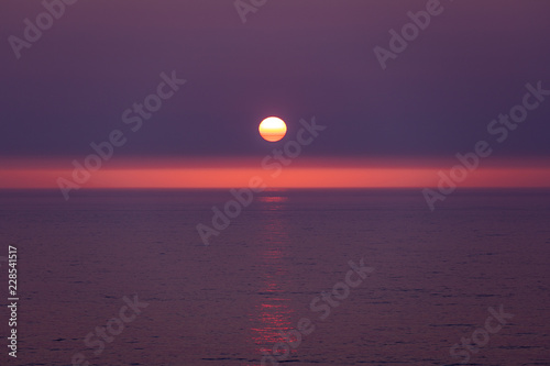Sunset mirage - red, orange and yellow stripes over the sun © Dmitry