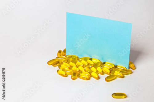 a lot of capsules pills on white background with copy space on the note for text . photo