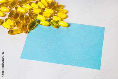 a lot of capsules pills on white background with copy space on the note for text . photo