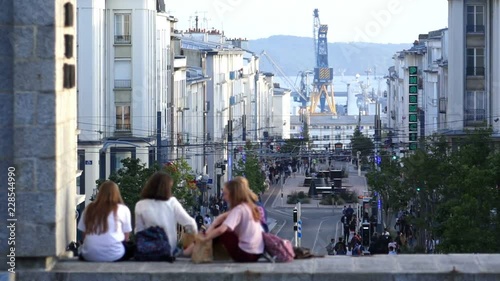 Four blurred teenage girls sitting and eating fast-foods in the street - blurred - perspective view in Brest, France - full hd