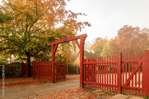 Klampenborg, Denmark - 15 october 2018: The Red Gate to Jaegersborg Dyrehave. This gate is located next to the Klampenborg Station. Autumn colors photo