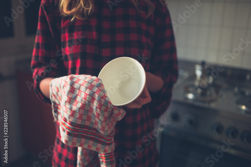 Fotografie Young woman doing the dishes