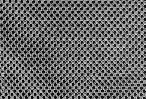 grey breathable porous poriferous material for air ventilation with holes. Black and white Sportswear nylon texture photo