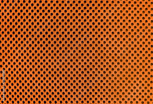 orange breathable porous poriferous material for air ventilation with holes. Sportswear material nylon texture
