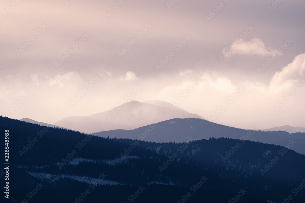Dramatic winter storm blows over a cold barren landscape at sunset Dramatic winter storm blows over a cold barren landscape at sunset