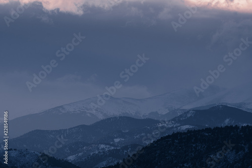 Dramatic winter storm blows over a cold barren landscape at sunset © Tabor Chichakly