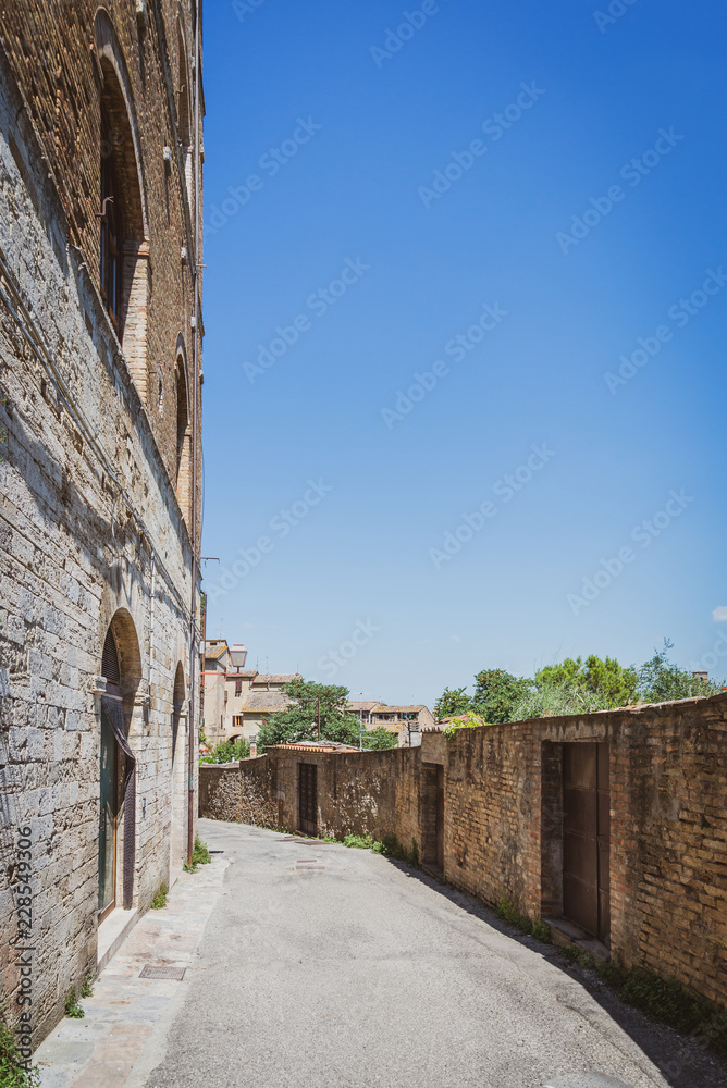 Empty street on the edge of ancient town in Italy San Gimignano