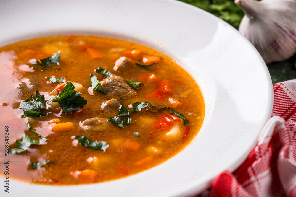 Traditional Hungarian goulash soup on the table. Traditional Hungarian goulash soup on the table.