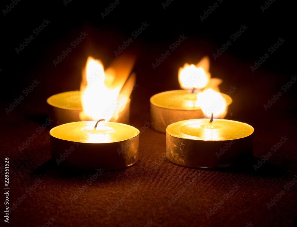 Group of burning candles on black background Group of burning candles on black background