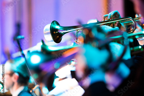 Photography A person playing a trumpet with a mute during a concert