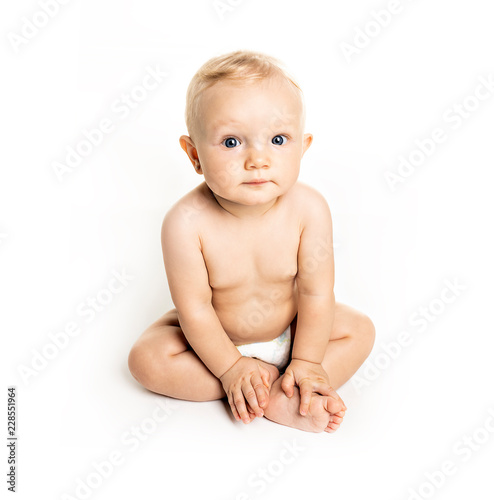 A six month old baby, sit on the floor