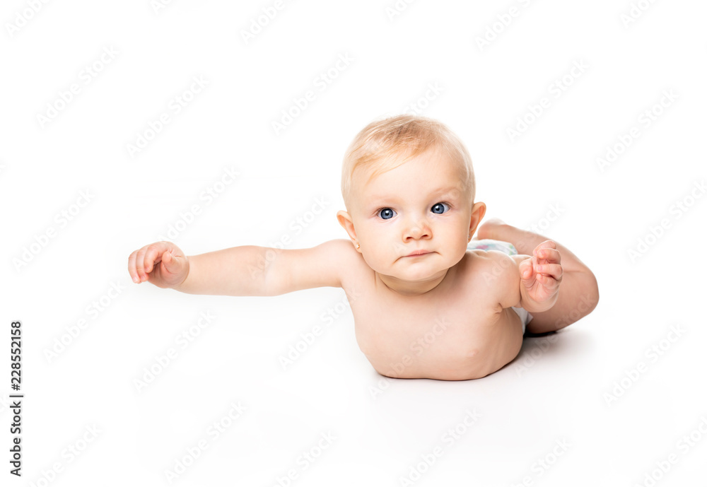 Cute baby with beautiful blue eyes on the white flooor Cute baby with beautiful blue eyes on the white flooor